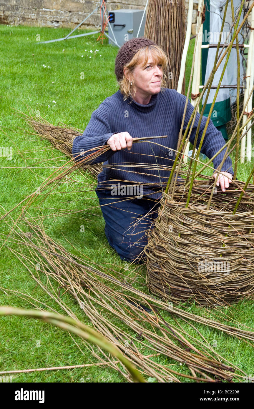 Woman  demonstrating basket weaving at  Bolsover castle Derbyshire  East Midlands England UK Stock Photo