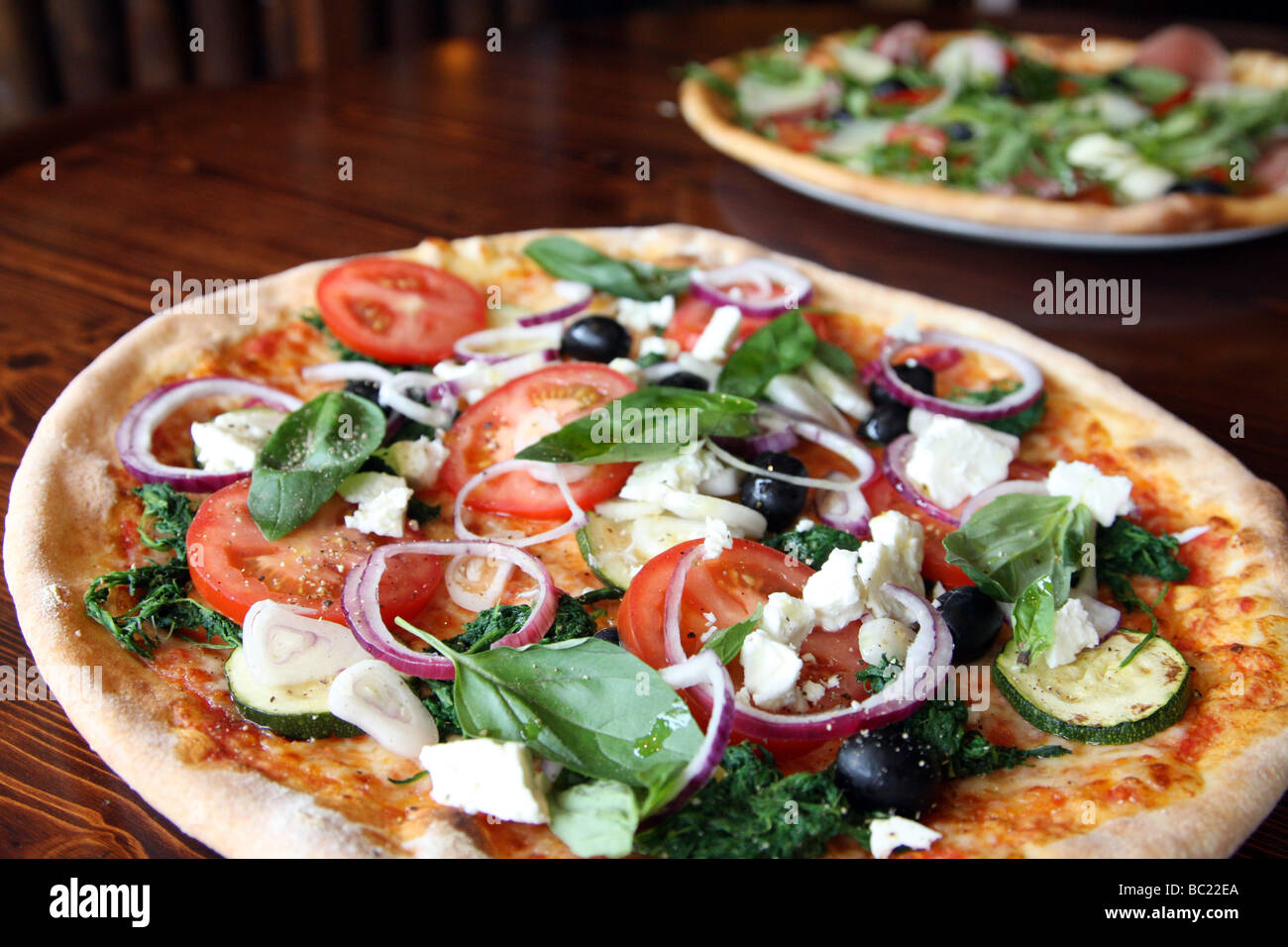 Pizzas topped with delicious looking vegetables. Stock Photo