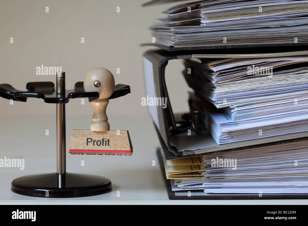 Stamp with inscription Profit next to a pile of files Stock Photo