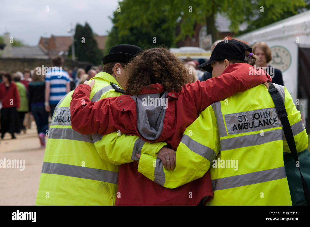 Woman being helped by two members of  the St.Johns Ambulance organization,a leading UK charity, Derbyshire England UK Stock Photo