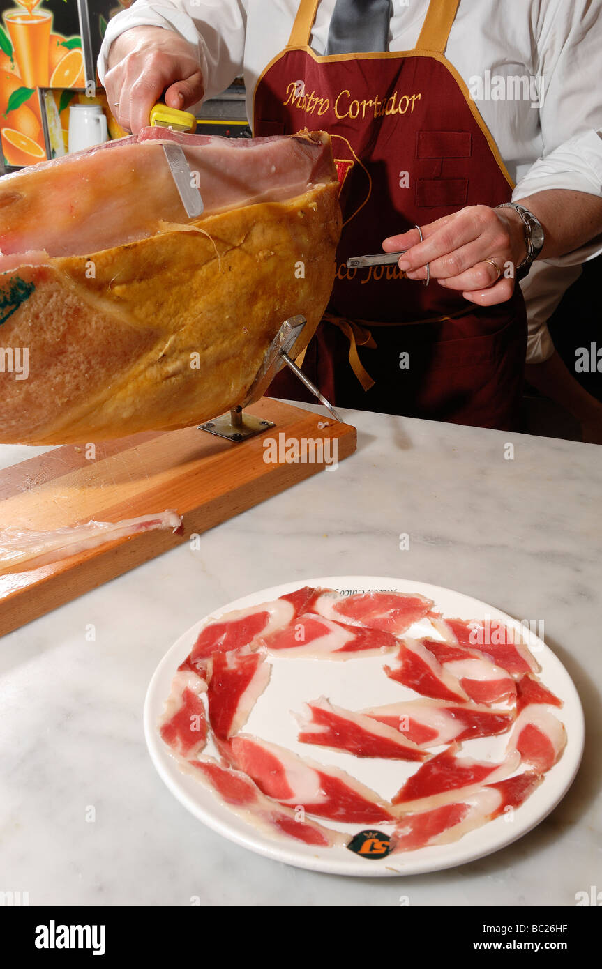 Cutting Spanish ham, process of preparation and it cuts Stock Photo Alamy
