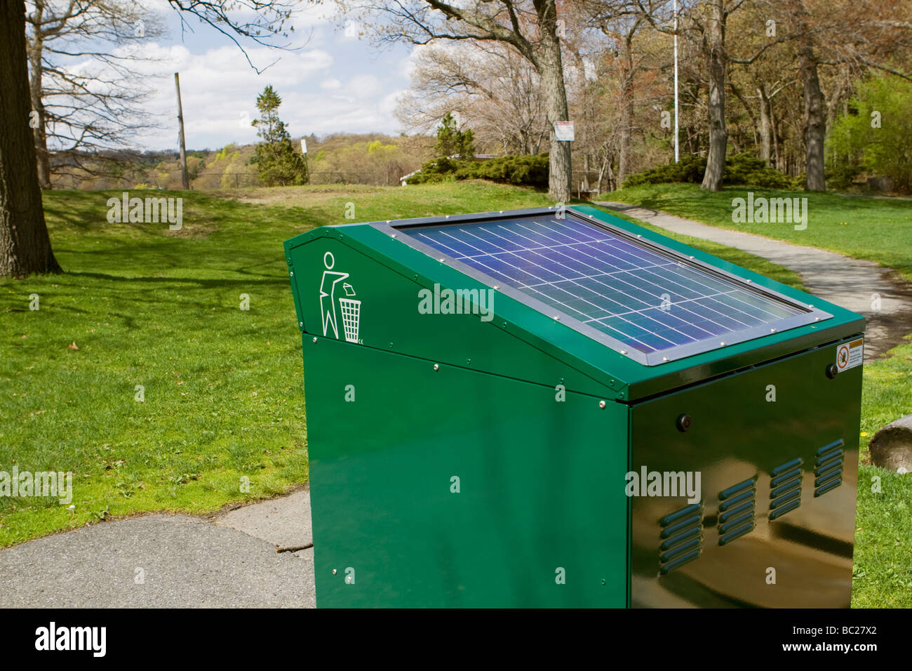 Big modern matte trash bin with an oval inlet, solar panal deployed on top,  black color, deployed at park on Craiyon