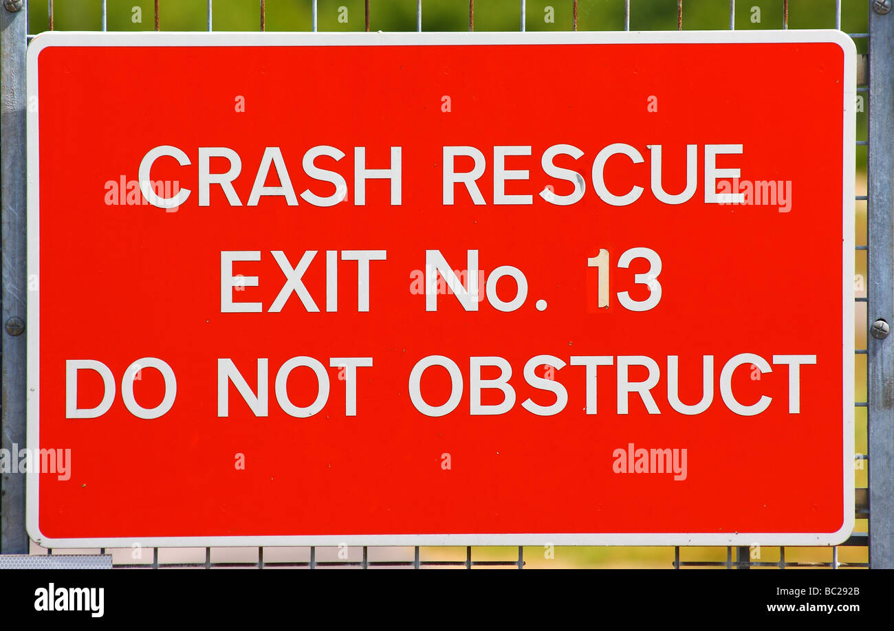 Red warning crash rescue exit sign at Farnborough Airport Stock Photo