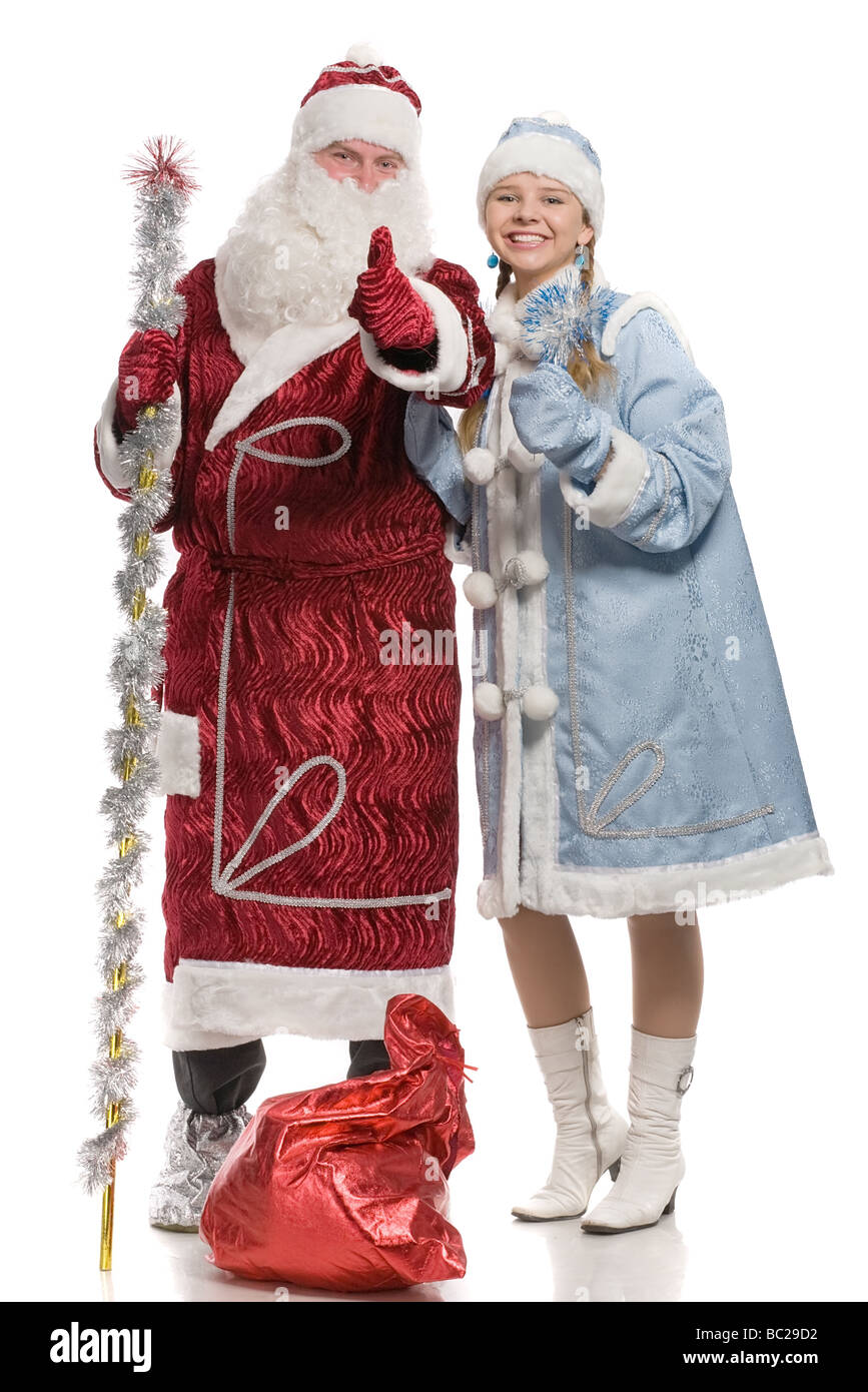 Santa Claus and snow maiden giving thumbs up sign isolated on white Stock Photo