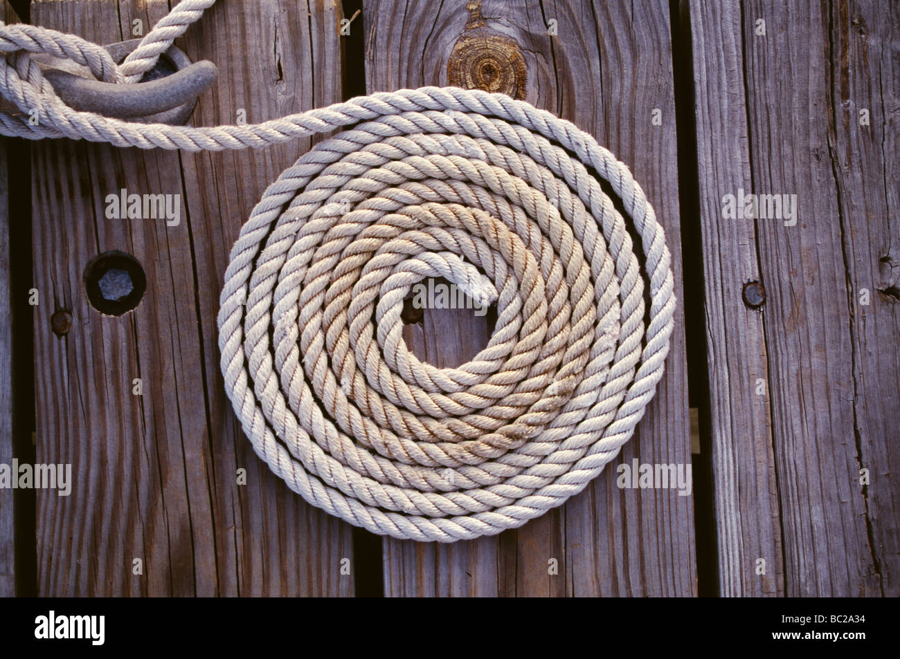 coil of boating rope on a quayside Stock Photo Alamy