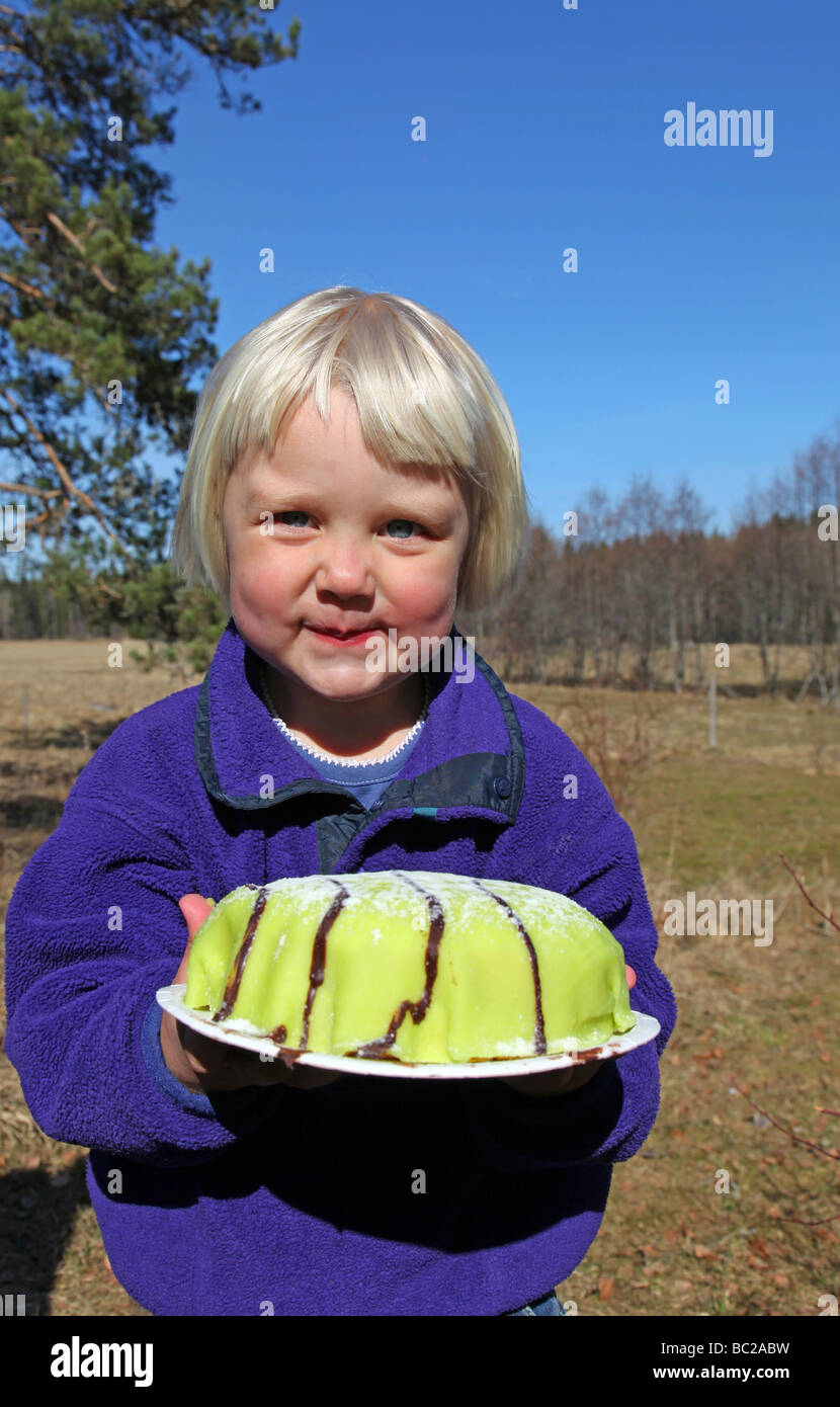 Young girl holding marzipan cake Stock Photo - Alamy