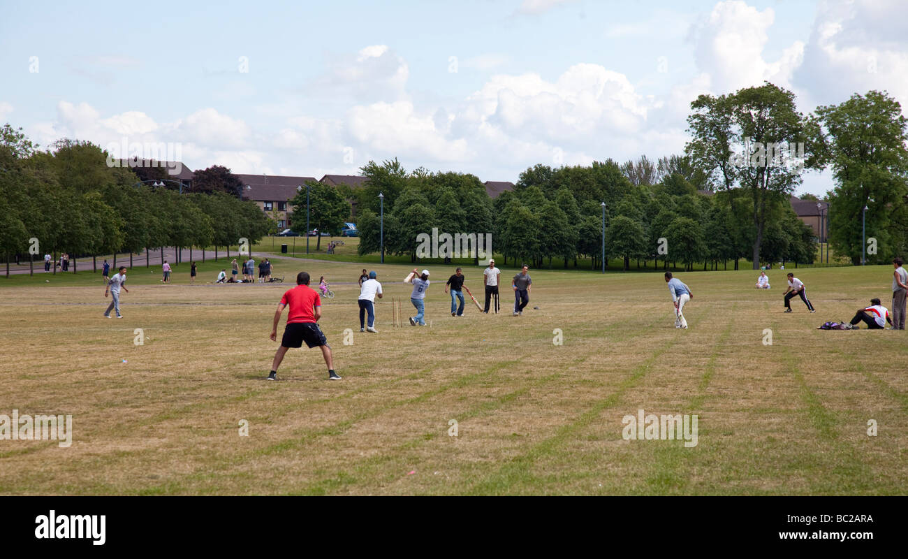 Young Asian men playing cricket on Glasgow Green Stock Photo - Alamy