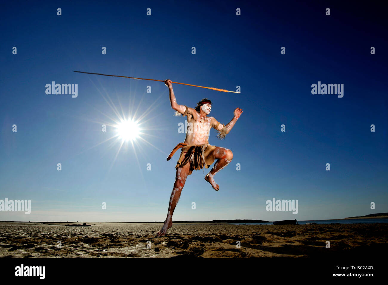 Budawang elder Noel Butler 59 from New South Wales Australia performs an aboriginal fishing dance against a blue sky Stock Photo