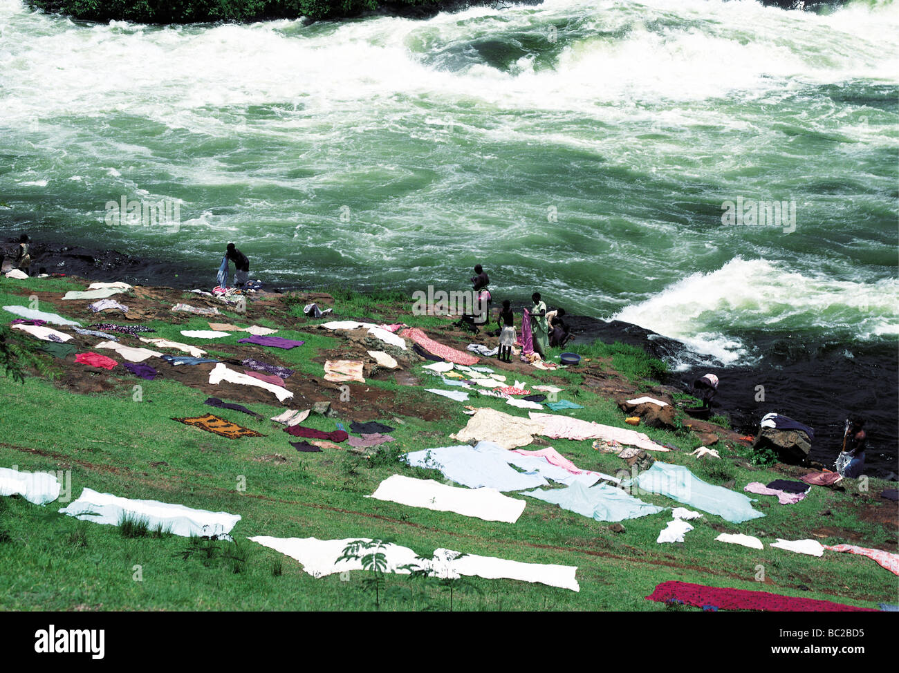 Washing spread on the ground to dry at side of River Nile Bujagali Falls Uganda East Africa Stock Photo