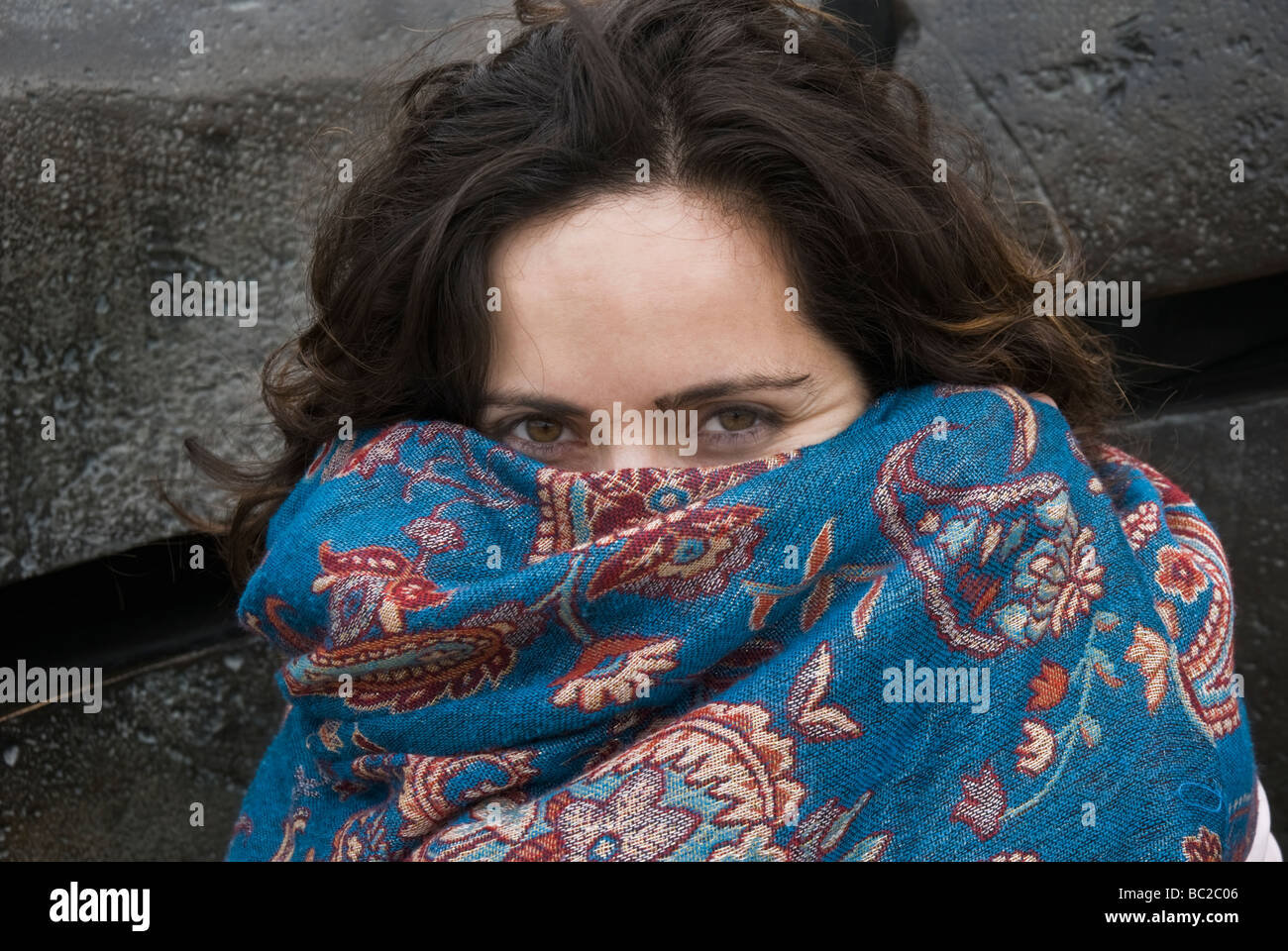 TURKISH WOMAN IN HER EARLY THIRTY'S HIDING HER FACE WITH THE SHAWL Stock Photo