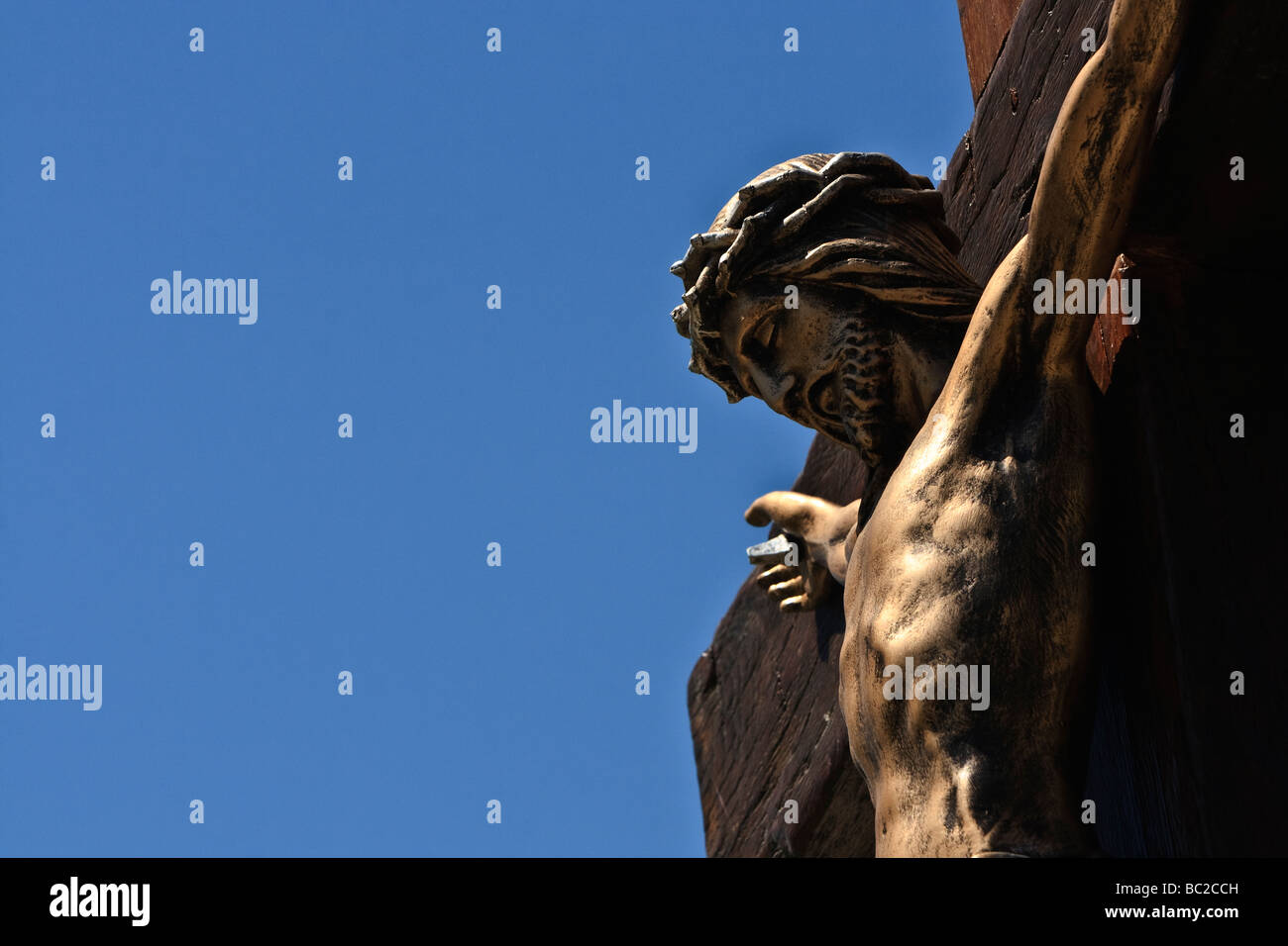Jesus on the cross with blue sky in the background Stock Photo