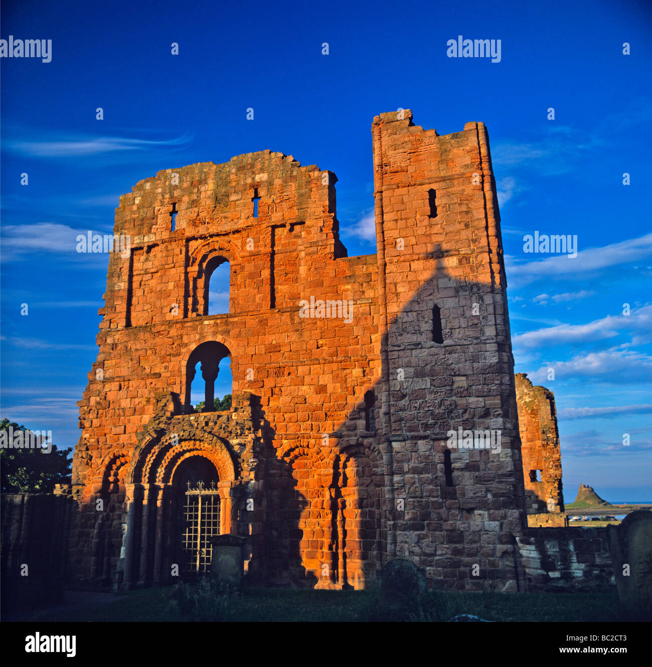Lindisfarne Priory on Holy Island with Lindisfarne Castle on the horizon in early morning light