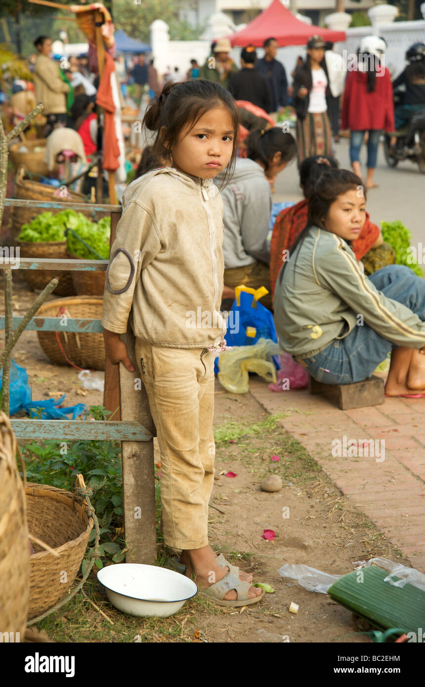 A young Lao girl standing by her families stall in Luang Prabang's daily fresh food market Stock Photo