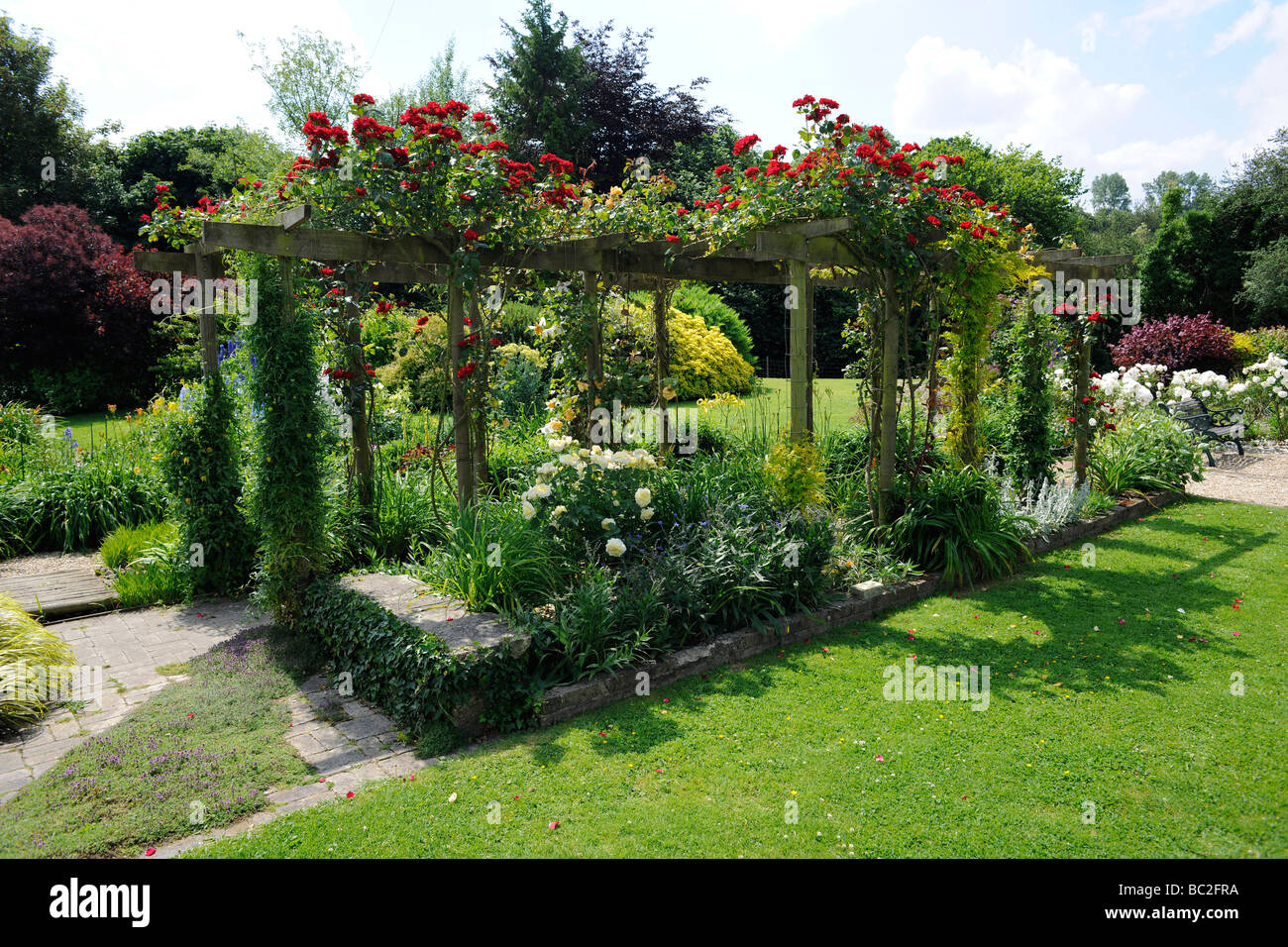English Garden with roses on a pergola, in Somerset Stock Photo