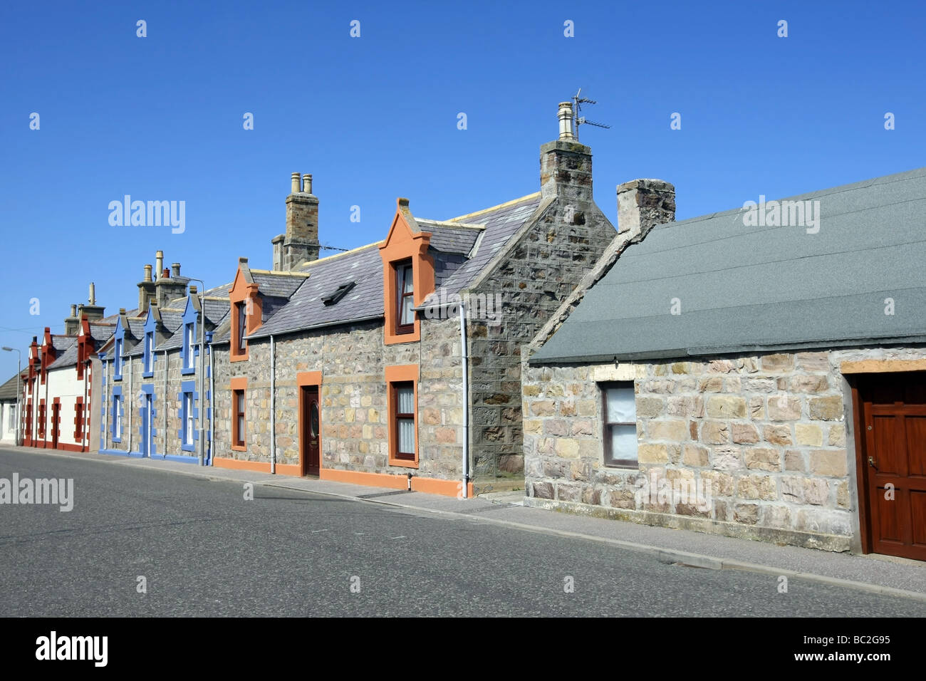 Brightly painted granite cottages at the picturesque former fishing village of Findochty, Aberdeenshire, Scotland, UK Stock Photo