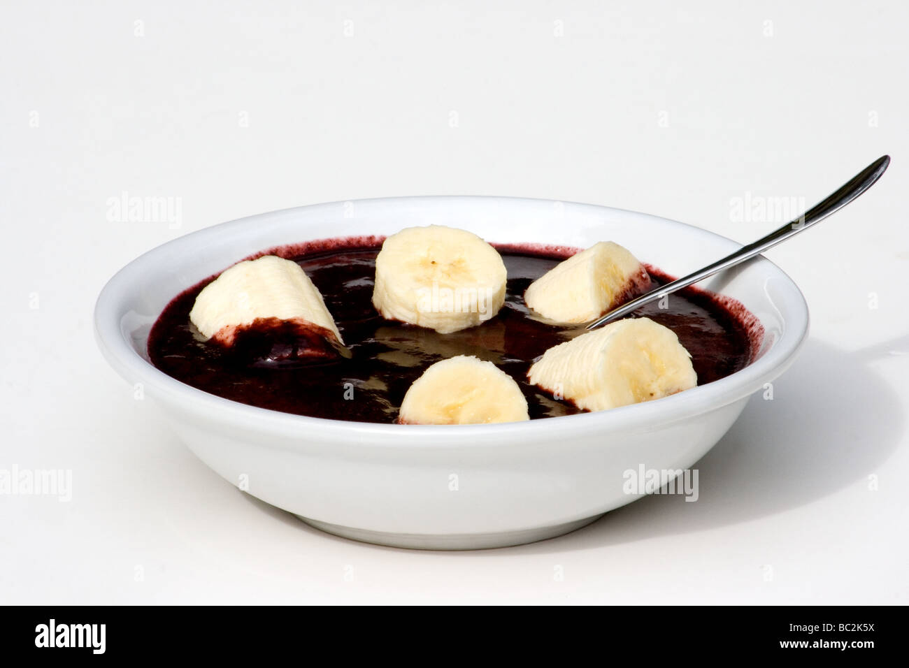 Close-uo of açai pulp served in a bowl with sliced banana Stock Photo