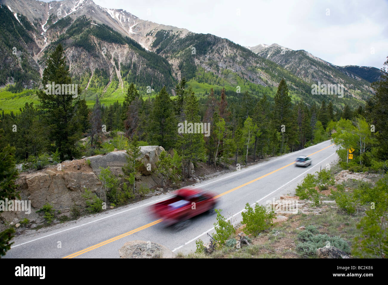 High overview of speeding cars on state road Rt 82 west of Twin Lakes Reservoir Lake County San Isabel National Forest Colorado Stock Photo