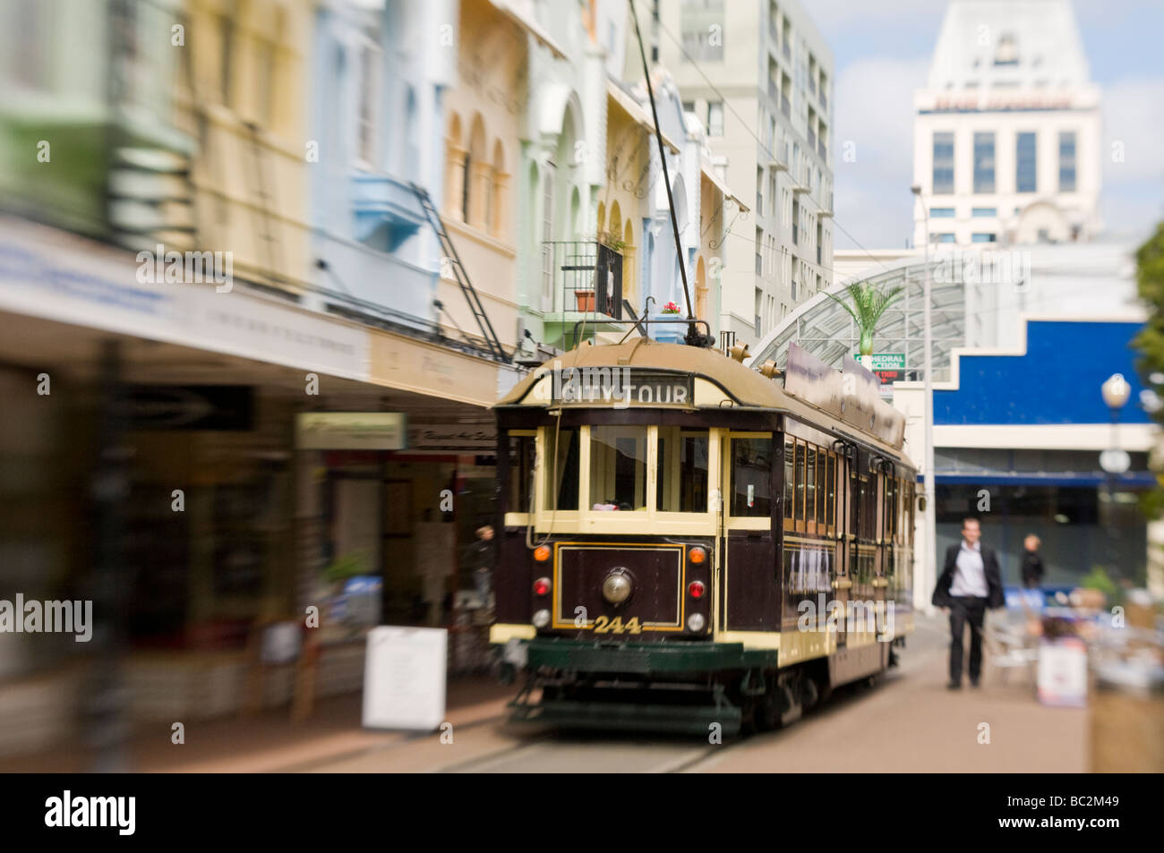 Selective focus: Christchurch tram passes from Cathedral Junction thru the Spanish Mission style shopfronts of New Regent Street Stock Photo