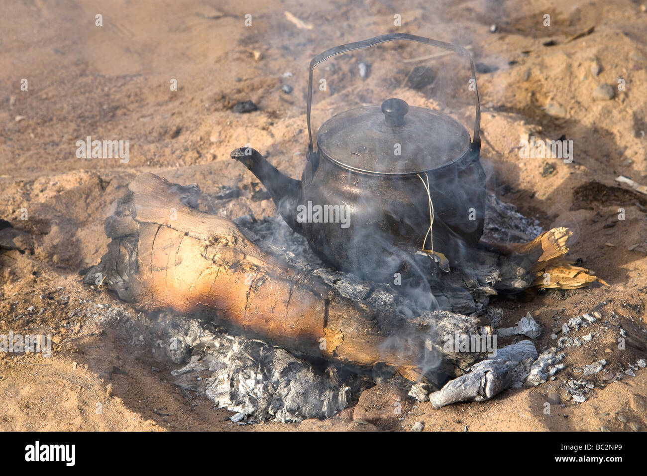 Kettle coming to boil on open fire while camping in the Eastern Desert