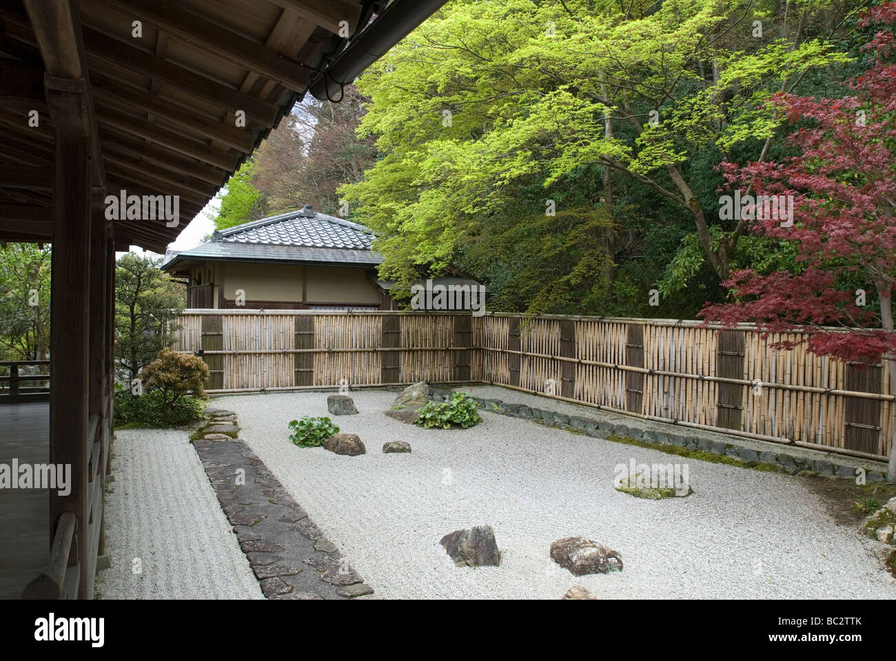 A Dry Landscape Garden With Raked White Gravel And Large Rocks In