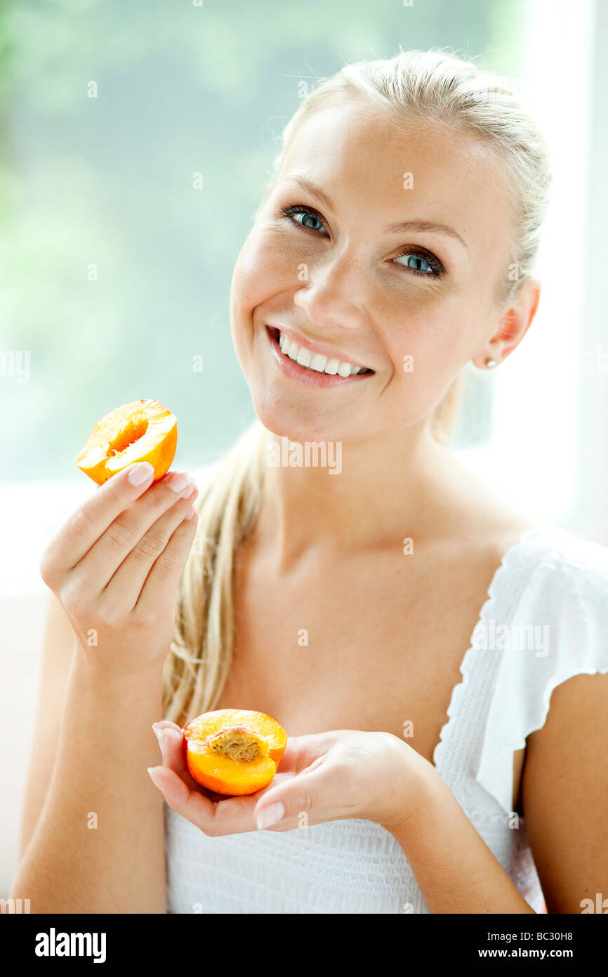 Woman eating Nectarine Stock Photo Alamy