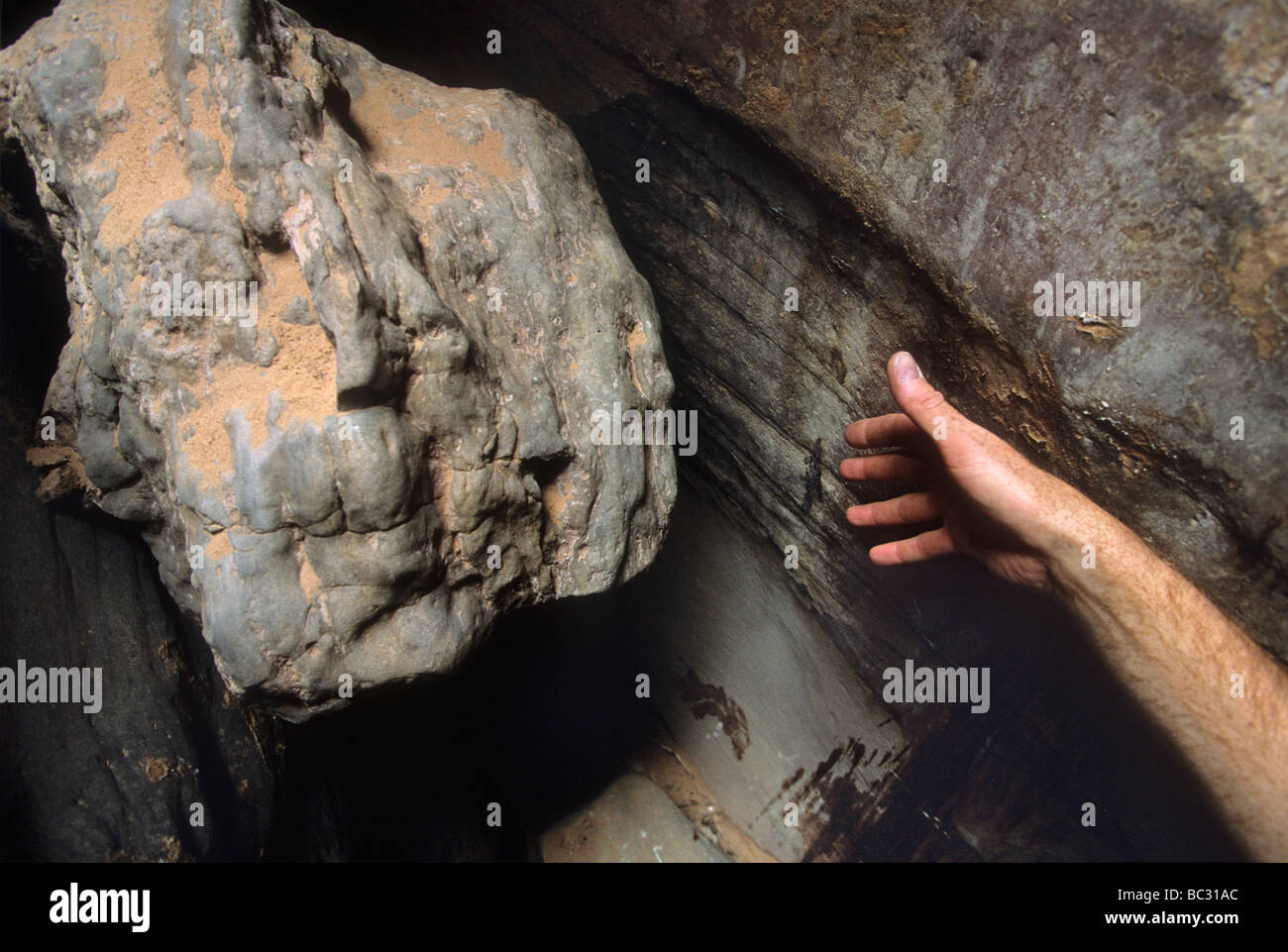 A hand indicates the approximate position where Aron Ralston's hand was trapped by a chockstone (to the left of the hand), and R Stock Photo