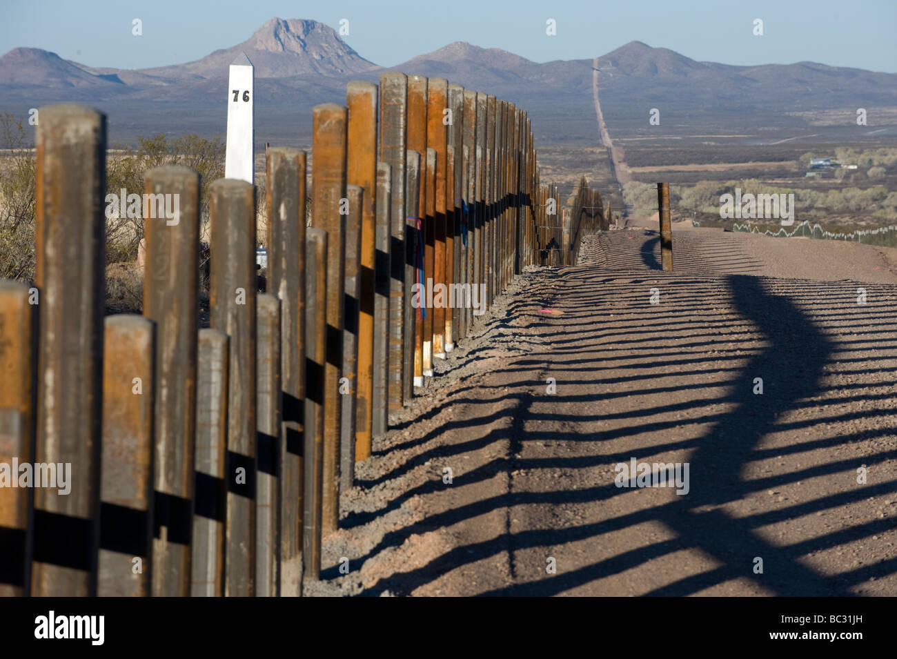 the-new-post-rail-border-fence-runs-next-to-the-original-border-markers-BC31JH.jpg