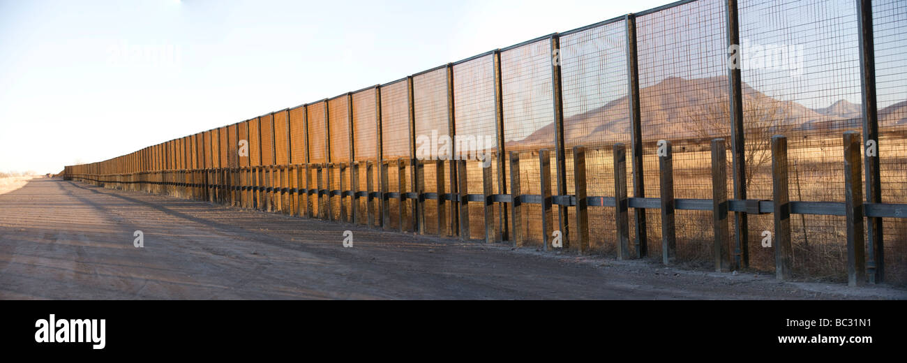 A pedestrian-style fence runs along the Mexican border in Arizona. Stock Photo