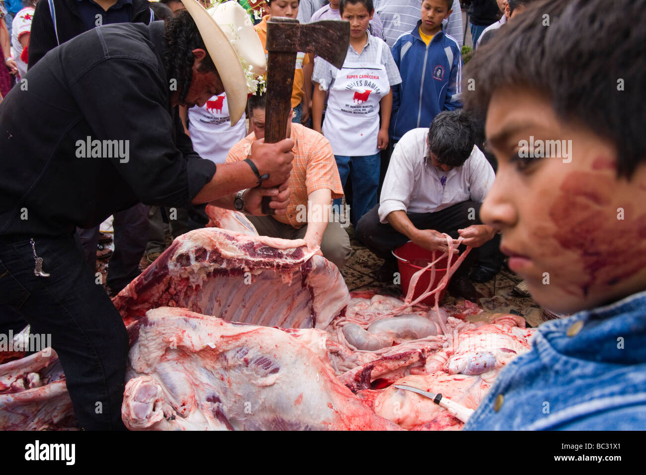 Men butcher a bull in Paracho, Michoacan, Mexico. Stock Photo