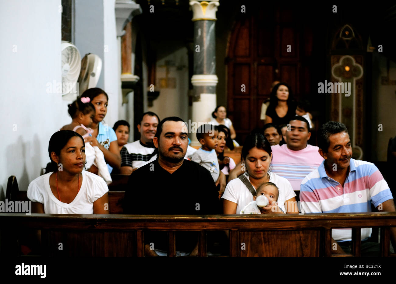 Latin American families attend mass on the Caribbean Island of Margarita in  Venezuela. Stock Photo