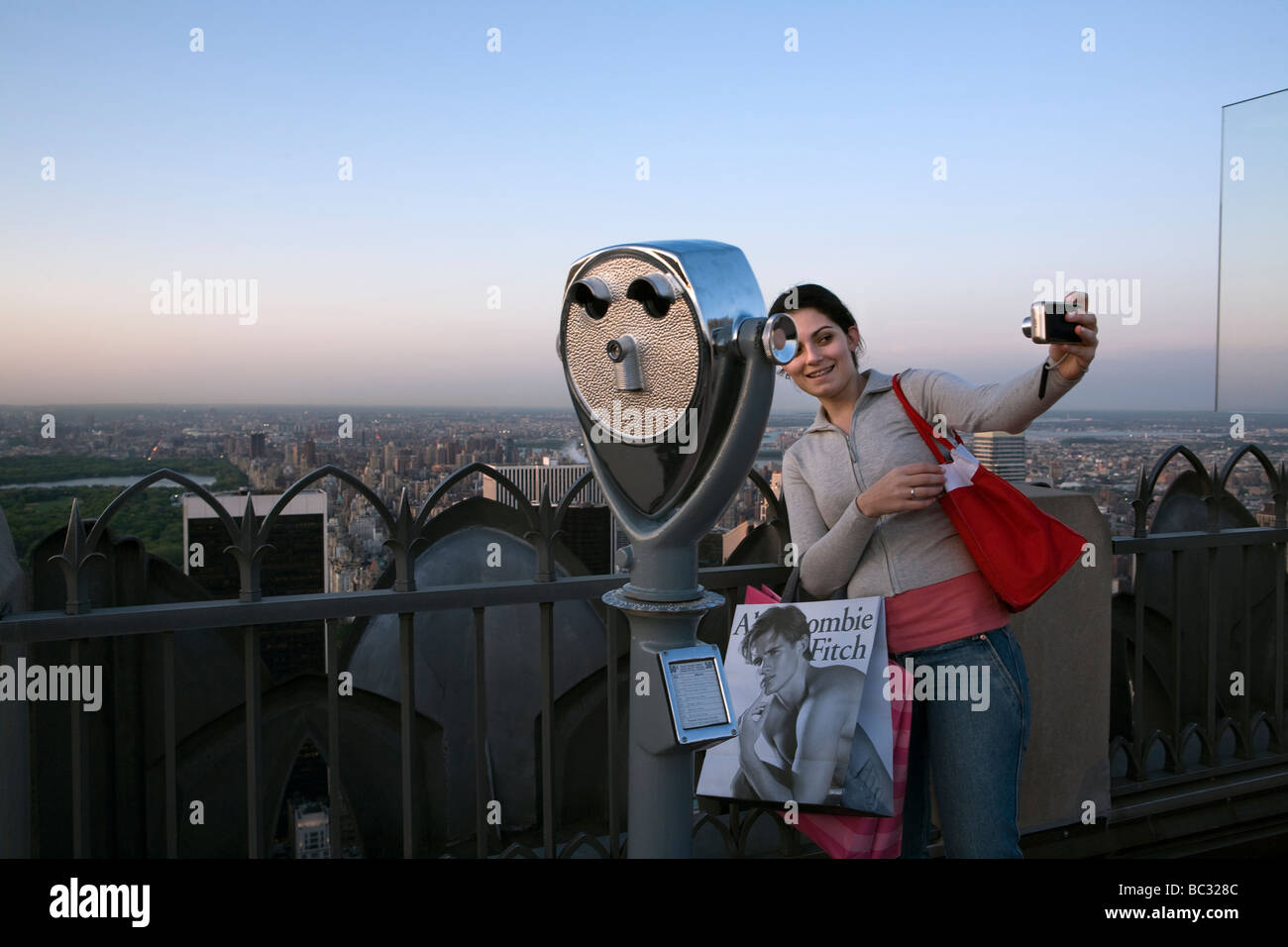 A young woman takes a self portrait on the Rockefeller Center observation deck in New York. Stock Photo