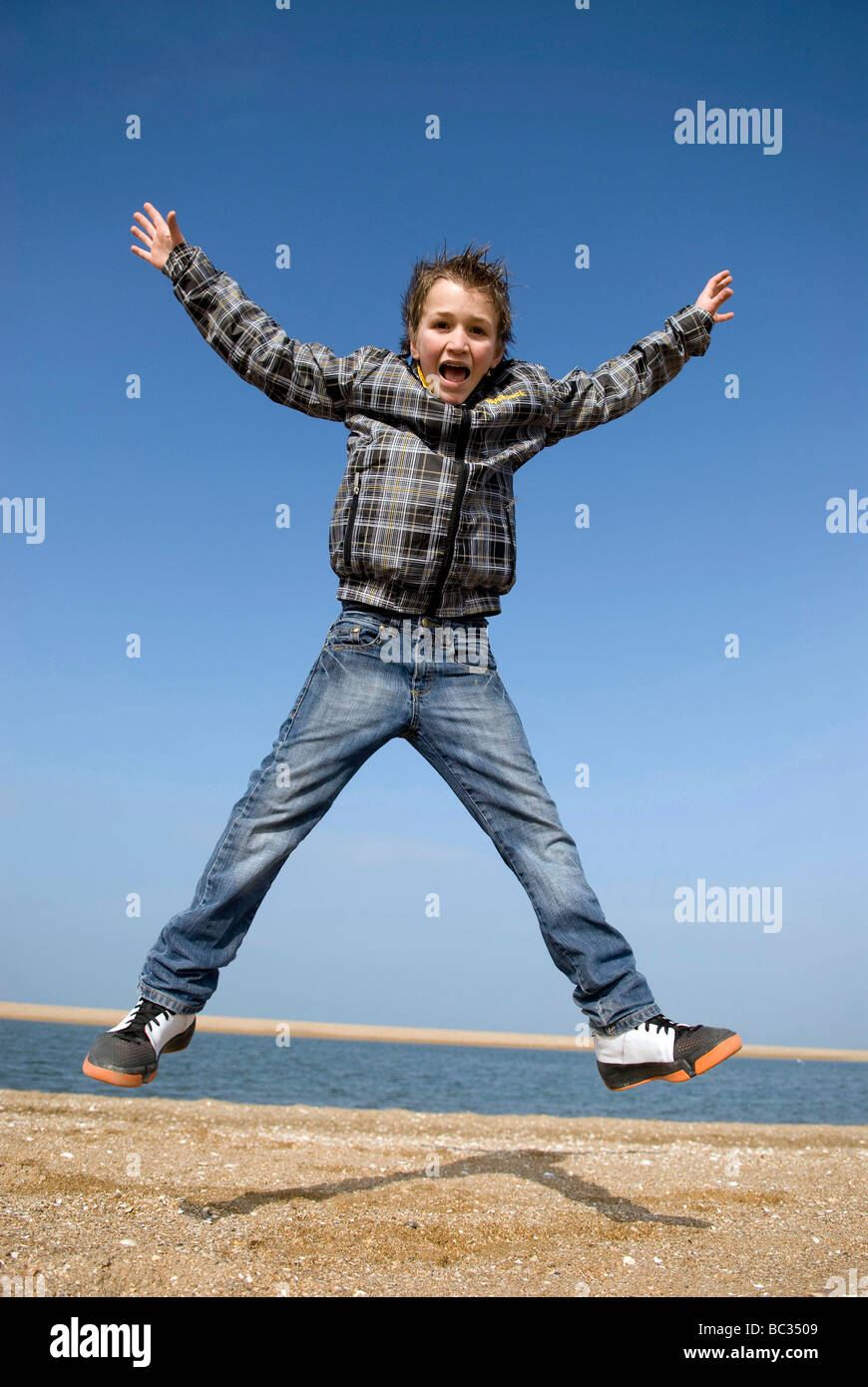 Child jumping into the air Stock Photo
