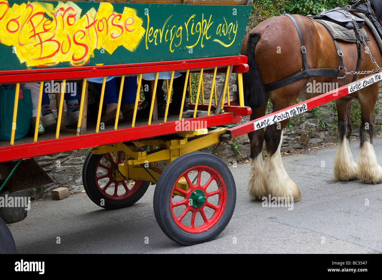Decorated Village farm cart & heavy Horse-bus services; Village tourist public transport in Polperro, Cornwall, South-east England, UK Stock Photo