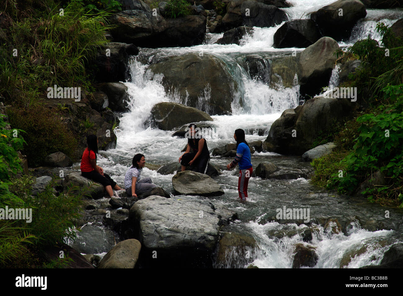 Girls washing clothes in the river, near Bontoc, Mountain Province, North Luzon, Philippines Stock Photo