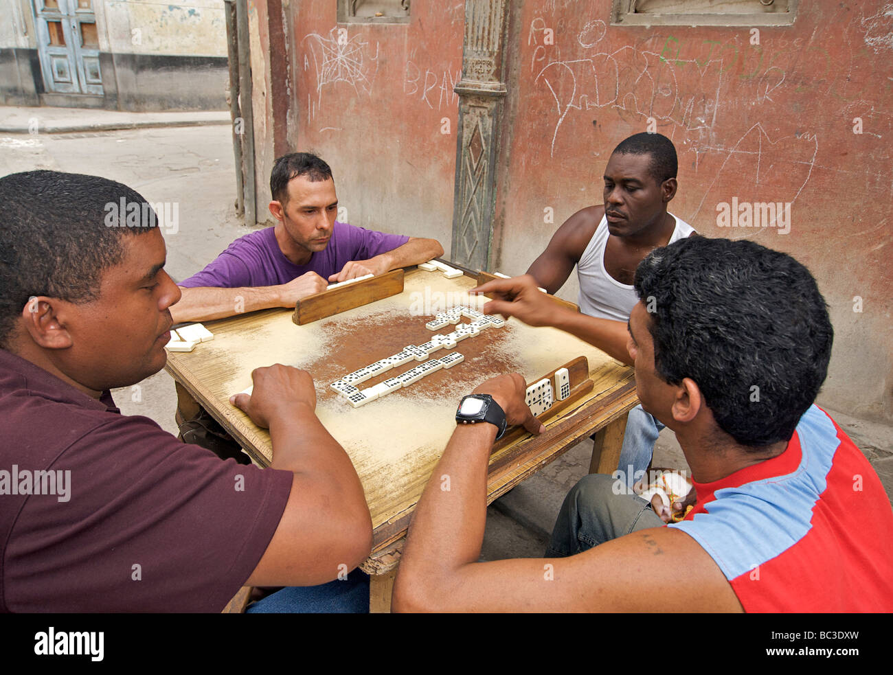 Cuban men playing dominoes in the street, Habana Vieja. Old Havana, Cuba Stock Photo