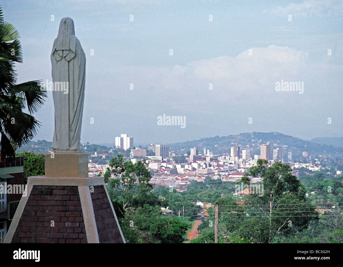 Statue of Virgin Mary at Roman Catholic Cathedral overlooking modern capital city of Kampala Uganda East Africa Stock Photo