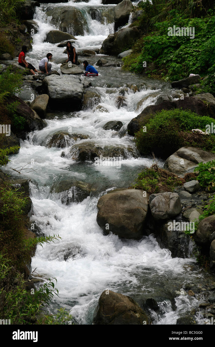 Girls washing clothes in the river, near Bontoc, Mountain Province, North Luzon, Philippines Stock Photo
