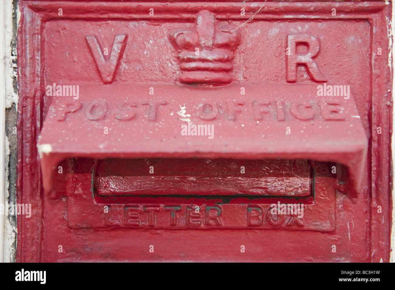 Close up of red Victorian Post Office Cast Iron letter box Stock Photo