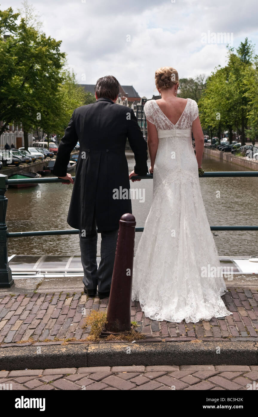 Bride and Groom stand on a bridge over the Prinsengracht canal in ...