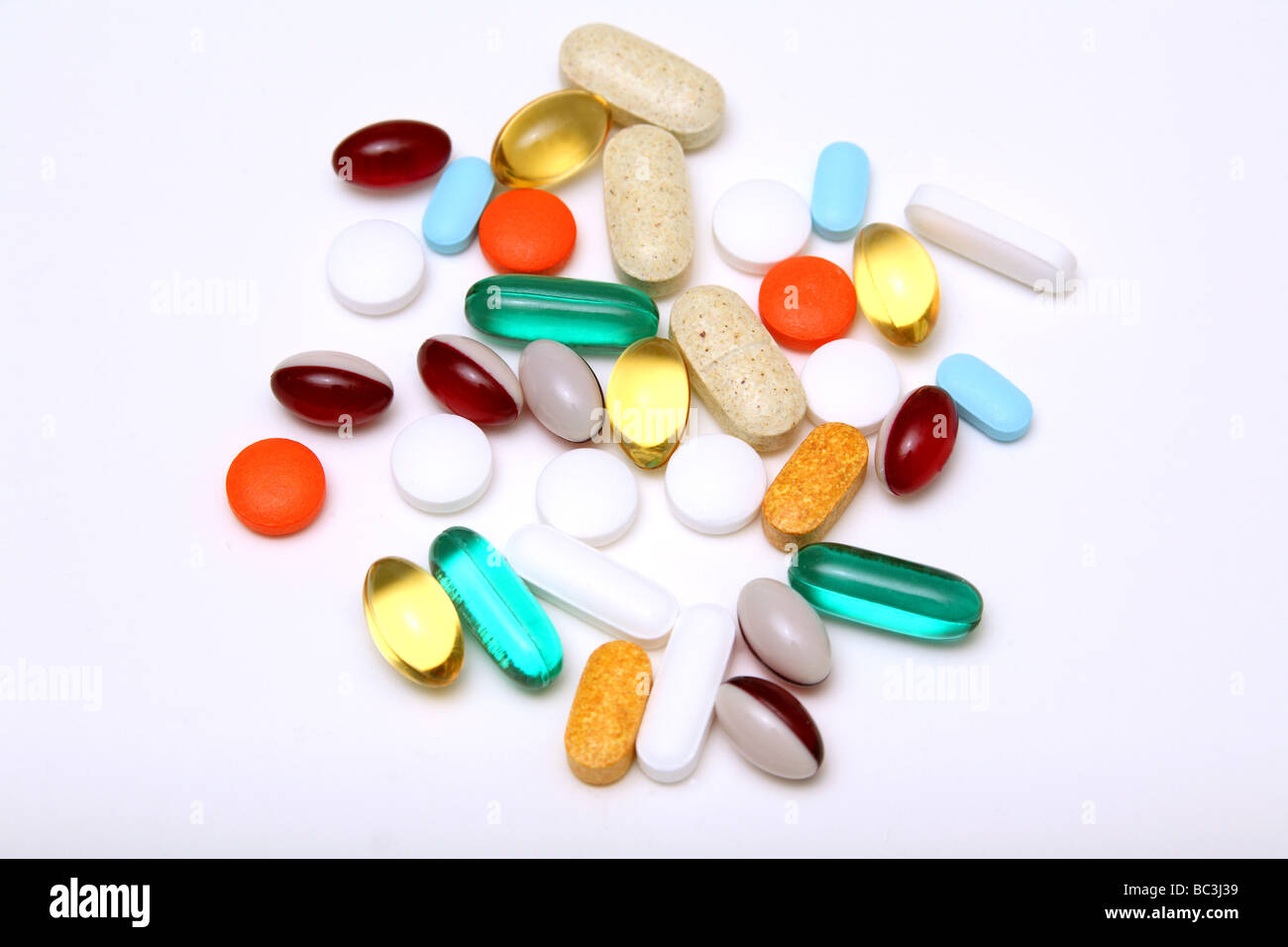 medication and vitamin pills tablets and softgels on neutral background Stock Photo