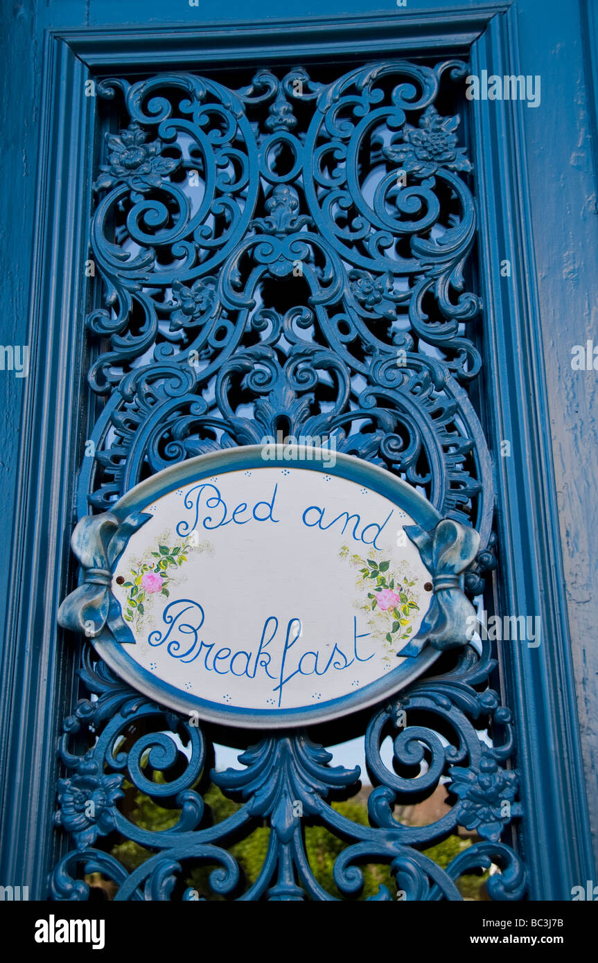 Ornate french metal window shutters with Gite bed and breakfast sign for english speaking visitors Stock Photo