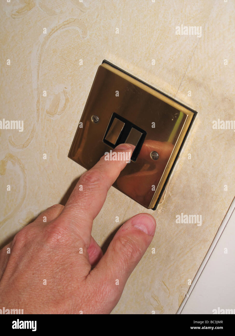 Male hand switching light switch Stock Photo