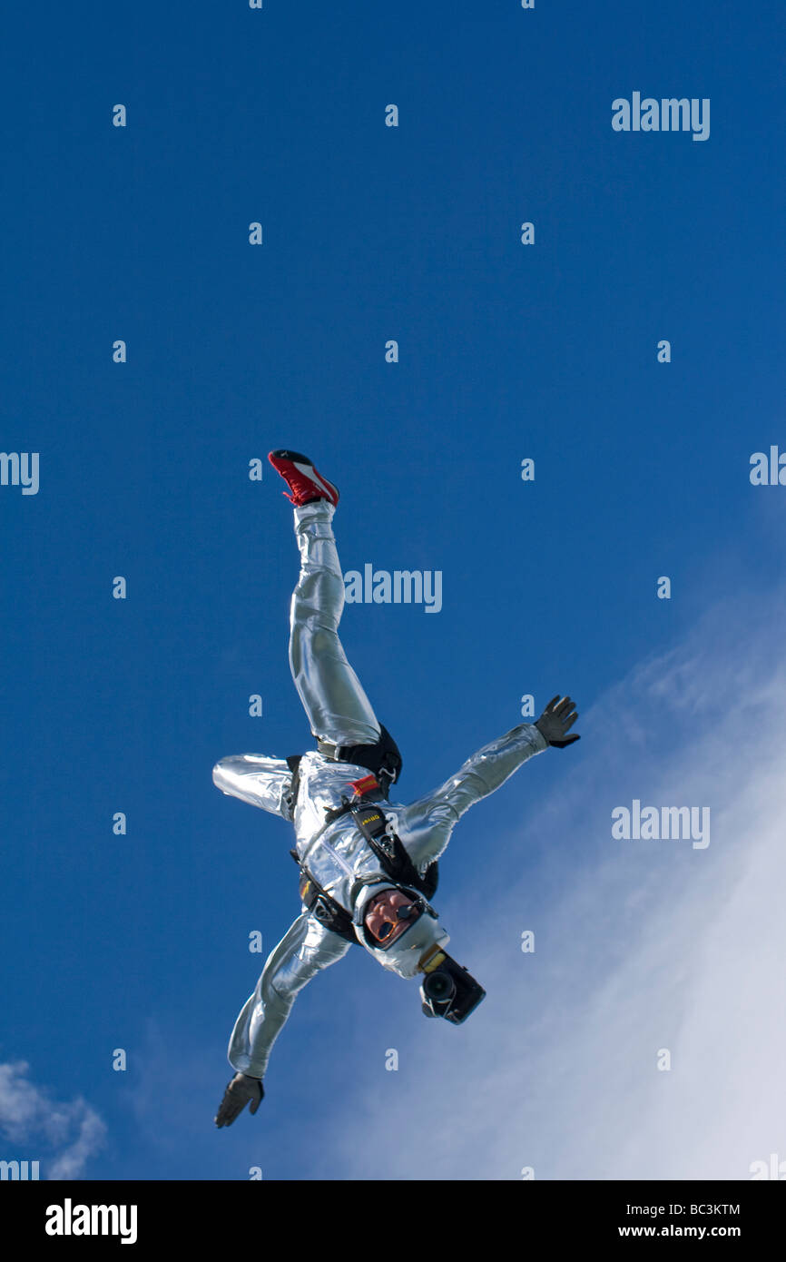 Skydiver is head down flying over a spectacular mountain scenery