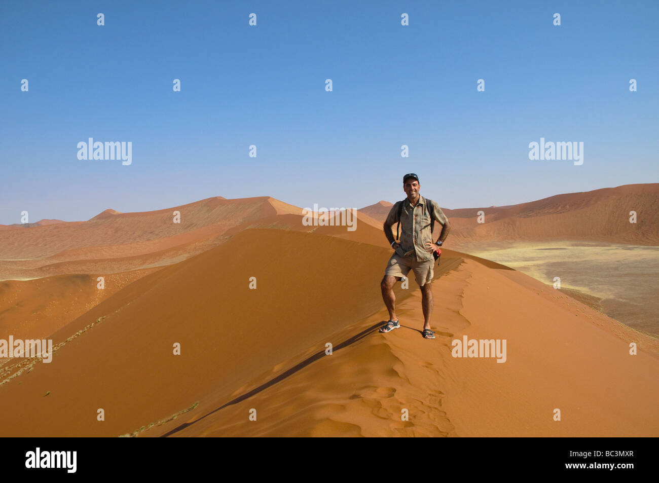 climber on the beautiful sand dune landscape of Sossusvlei National ...