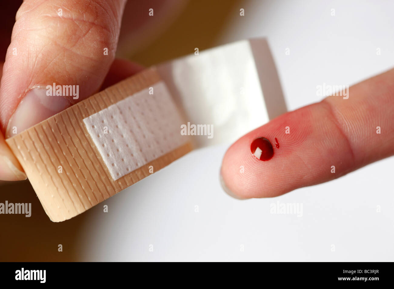 Plaster applyed to a little wound on a finger Stock Photo