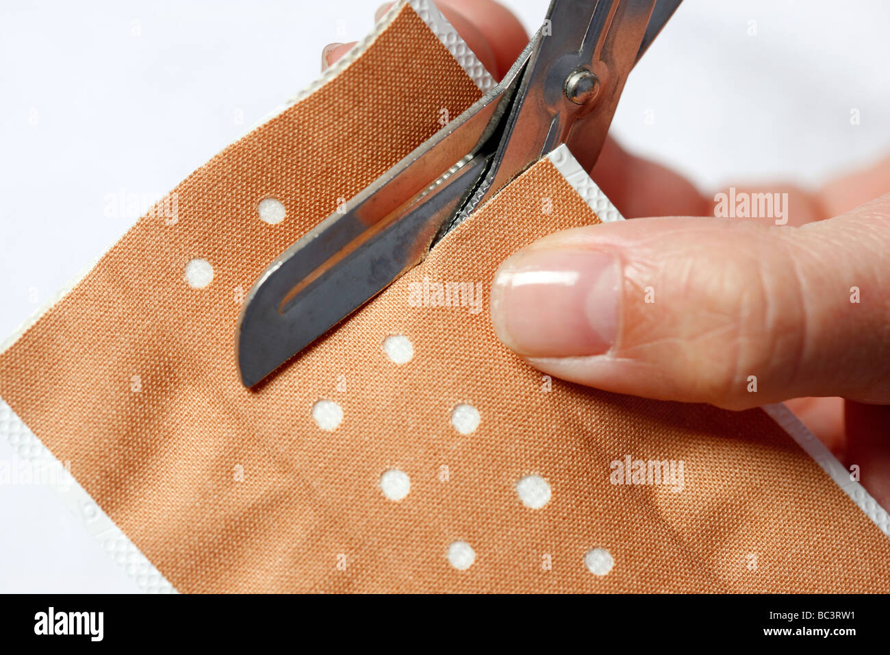 Plaster cutting to apply the plaster to a little wound Stock Photo Alamy