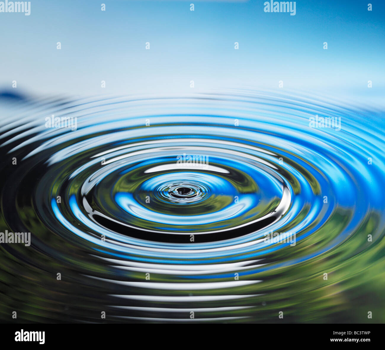 Liquidwater droplet falling into pond hi-res stock photography and