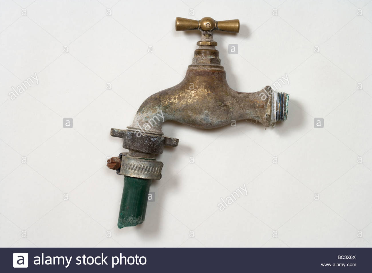 Old Style Water Tap With A Short Piece Of Garden Hose Stock Photo