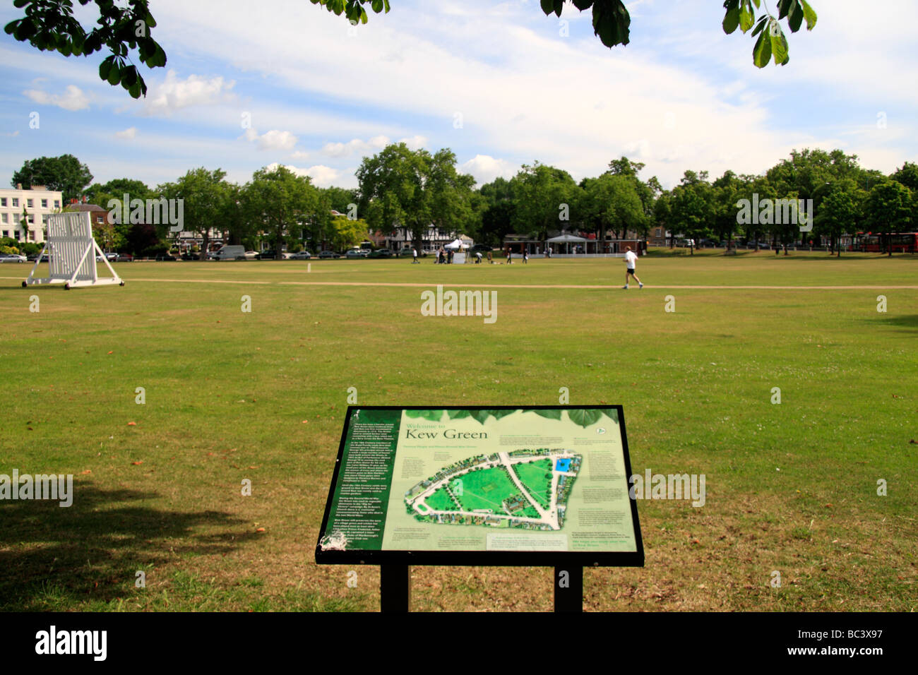 Looking across the cricket pitch of Kew Green, just outside the Royal Botanic Gardens, Kew, Surrey, England. Stock Photo