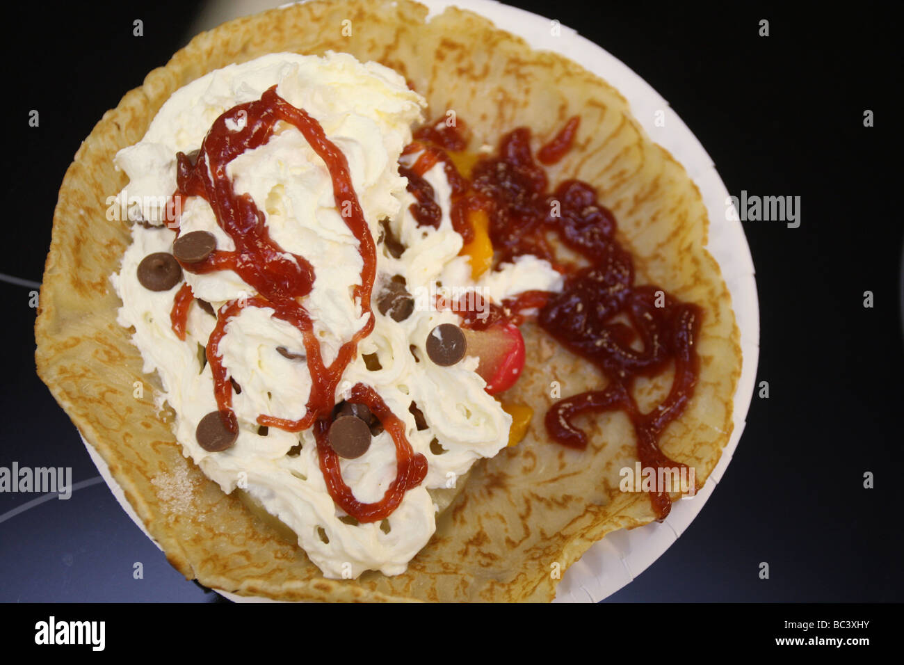 Crepe / pancake with a sweet filling of cream, jam chocolate Stock Photo